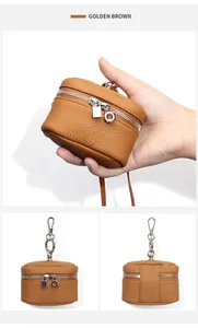 Macro view showing golden brown lychee grain leather texture and silver hardware details