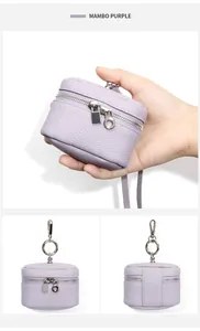 Close-up of Mambo Purple mini leather coin purse with silver zippers and pebble texture