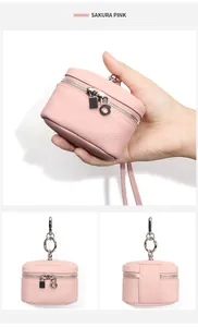 Detail of Sakura Pink leather coin purse featuring lychee grain texture and metal hardware