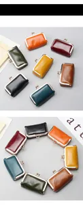 Macro detail of various vintage leather coin purses with metallic kiss-lock closures
