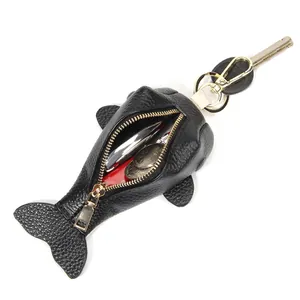 Black pebbled leather fish-shaped key pouch with gold zipper and metal keychain hook