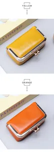 Macro detail of glossy oil wax leather coin purses in bright yellow and orange