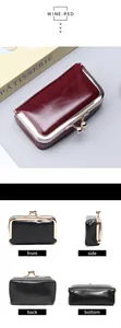 Detail view of vintage oil wax leather mini purse with kiss-lock clasp in wine red and black