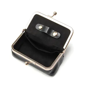 Vintage black oil wax leather mini jewelry purse with gold kiss-lock closure and interior strap