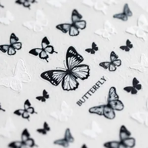 Detailed butterfly nail art stickers with fine wing patterns in black and white tones
