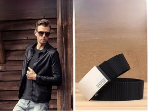 Detail view of durable black nylon canvas belt with a brushed silver metal buckle
