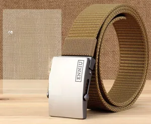 Close-up of khaki nylon web belt with silver metal automatic buckle on wooden background