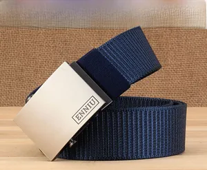 Detail of navy blue nylon belt featuring a brushed metal buckle on wooden surface