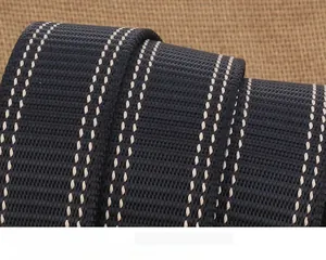 Macro detail of thick dark blue nylon belt strap with tank pattern weave and white stripes