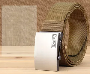 Close-up of khaki nylon tactical belt with brushed metal buckle on rustic wooden background
