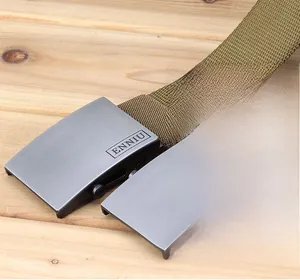 Close-up of durable thickened nylon tactical belts with matte alloy buckles on wood surface