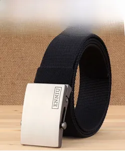 Close-up of thick black nylon belt showing brushed metal buckle and tight weave texture