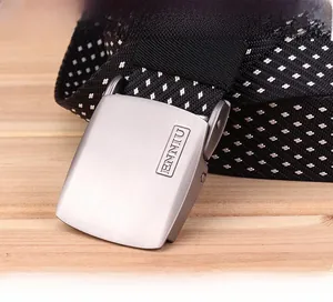 Macro detail of men's nylon tactical belt showing matte silver buckle and buckle mechanism