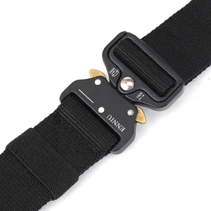 Close-up of matte black tactical buckle with brass buttons on a black nylon belt