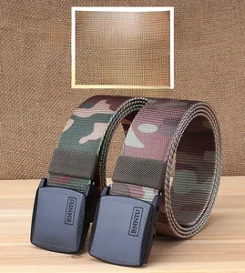 Detail of military camo nylon belt with durable black plastic buckle on rustic wood surface