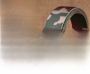 Tactical nylon camouflage belt with a smooth black plastic buckle on a rustic wooden background