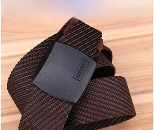 Detailed macro view of durable nylon woven belt with ENNIU brand logo on matte buckle