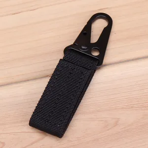Detail of a tactical nylon keychain with a metal eagle beak hook on wooden background