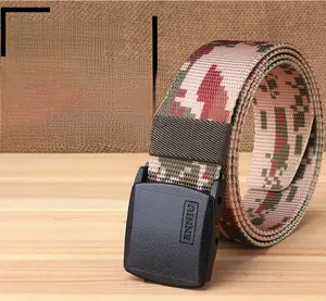 Detail of a pink camo nylon tactical belt with a matte black buckle on a rustic wooden table