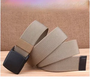 Detail of khaki braided nylon belt with black YKK buckle and dark brown leather tip