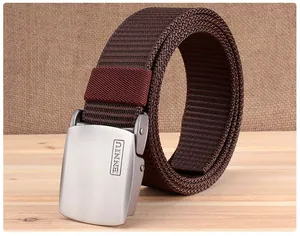 Detail of dark brown tactical canvas belt with brushed metal buckle and engraved logo