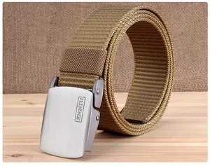 Close-up of khaki tactical nylon belt showing metal buckle texture and thick fabric