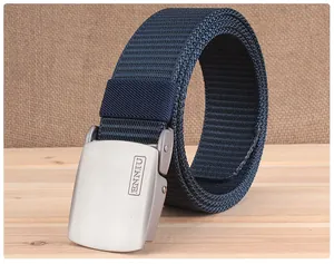 Detail of navy blue nylon woven tactical belt with matte silver metal buckle on wood background
