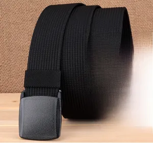 Detail of black nylon tactical belt with YKK plastic buckle on rustic background