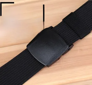 Close-up of black nylon tactical belt with matte YKK buckle on wood surface