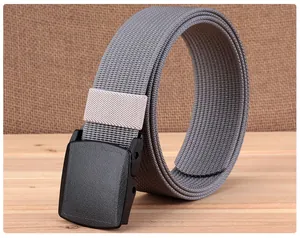 Macro view of grey nylon belt with YKK buckle on wood surface for outdoor use