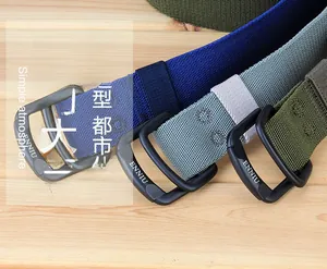 Close-up of elastic nylon belts in navy, grey, and green with double D-ring buckles