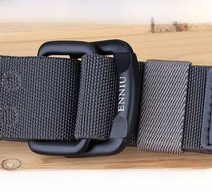 Close-up of matte black zinc alloy double ring buckle on grey elastic nylon belt