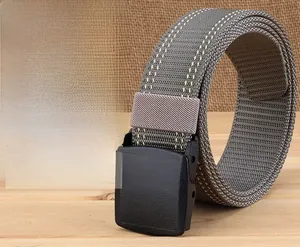 Close-up of gray nylon tactical belt with white stitching and black YKK plastic buckle