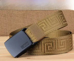 Detail of golden nylon belt with Greek meander pattern and matte black smooth buckle