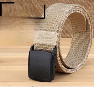 Close-up of thick khaki nylon tactical belt with black plastic buckle on wooden surface