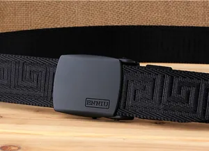 Detail of matte black metal automatic buckle with textured nylon web belt strap