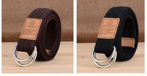 Détail de ceintures en toile avec boucles double D en métal et étiquettes en cuir