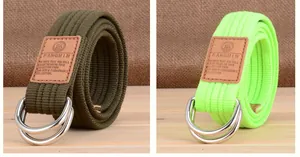 Détail de ceintures en toile avec boucles double D en métal et écussons en cuir