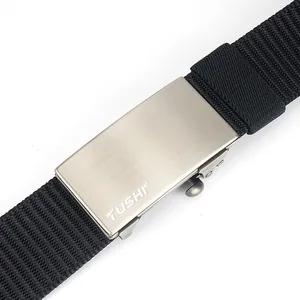 Close-up of TUSHI nylon belt showing the brushed metal buckle and woven texture details