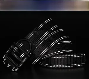 Macro shot of nylon tactical belt featuring three reflective strips and metal buckle