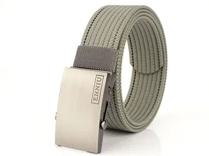 Detail of army green nylon belt with matte metal buckle and engraved logo