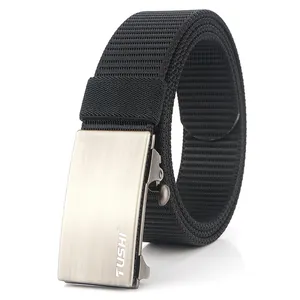 Close-up of black nylon belt with brushed silver metal buckle featuring logo detail