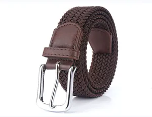 Close-up of dark brown elastic woven belt with polished silver pin buckle and leather tips