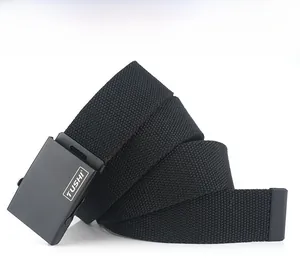 Detail of a black woven canvas belt with a matte black metal buckle and TUSHI logo