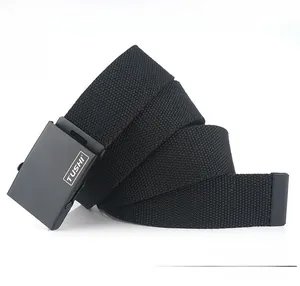 Detail of black nylon woven belt with matte metal buckle and protective metal end cap