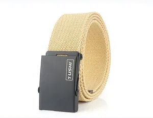 Close-up of khaki woven canvas belt with matte black TUSHI logo metal buckle