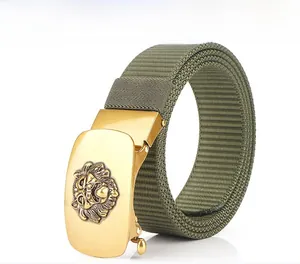 Close-up of golden metal automatic buckle with embossed lion head on green nylon belt