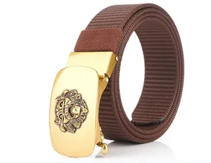 Detail of men's brown nylon belt featuring a 3D golden lion head automatic buckle