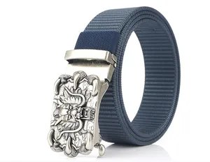 Detail of blue nylon belt with vintage silver automatic buckle featuring a 3D dragon relief