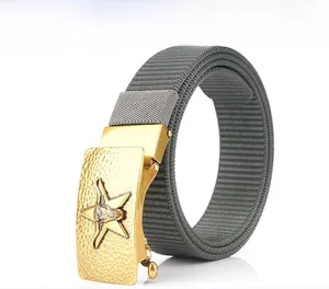 Detail of dark grey nylon belt with a gold textured buckle featuring star and bullhead logo